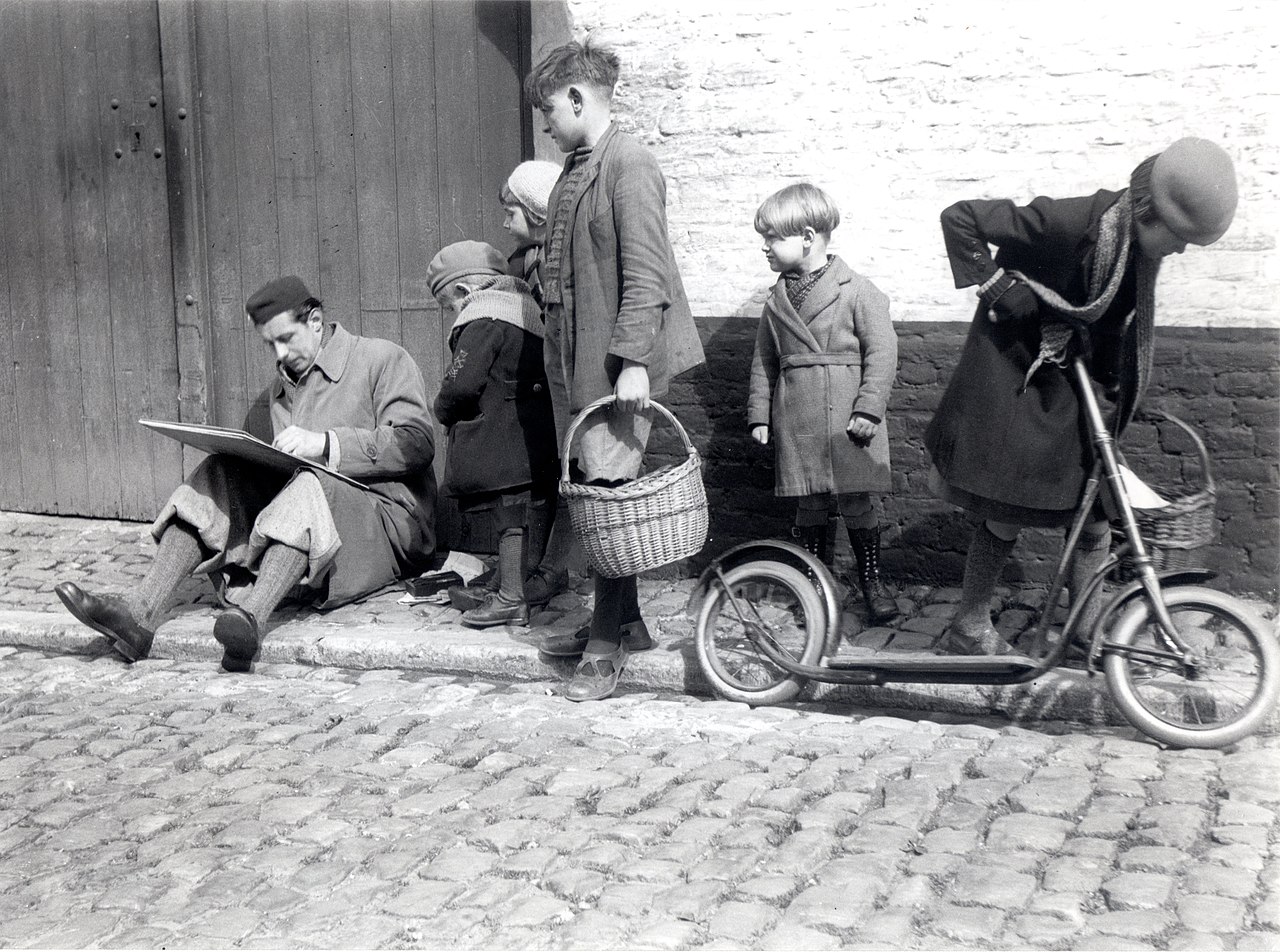 Black and white image with people dressed in Victorian style clothes and a child pushing a scooter.